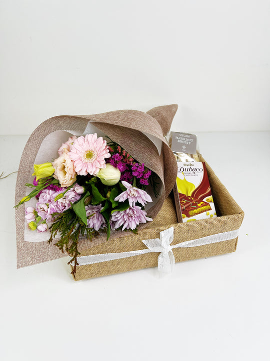Floral arrangement in a box with a white background